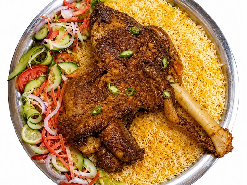 Mutton Mandi, Fragrant mandi rice topped with tender, slow-cooked mutton, served with vegetables and signature sauces, Sufraq Karachi
